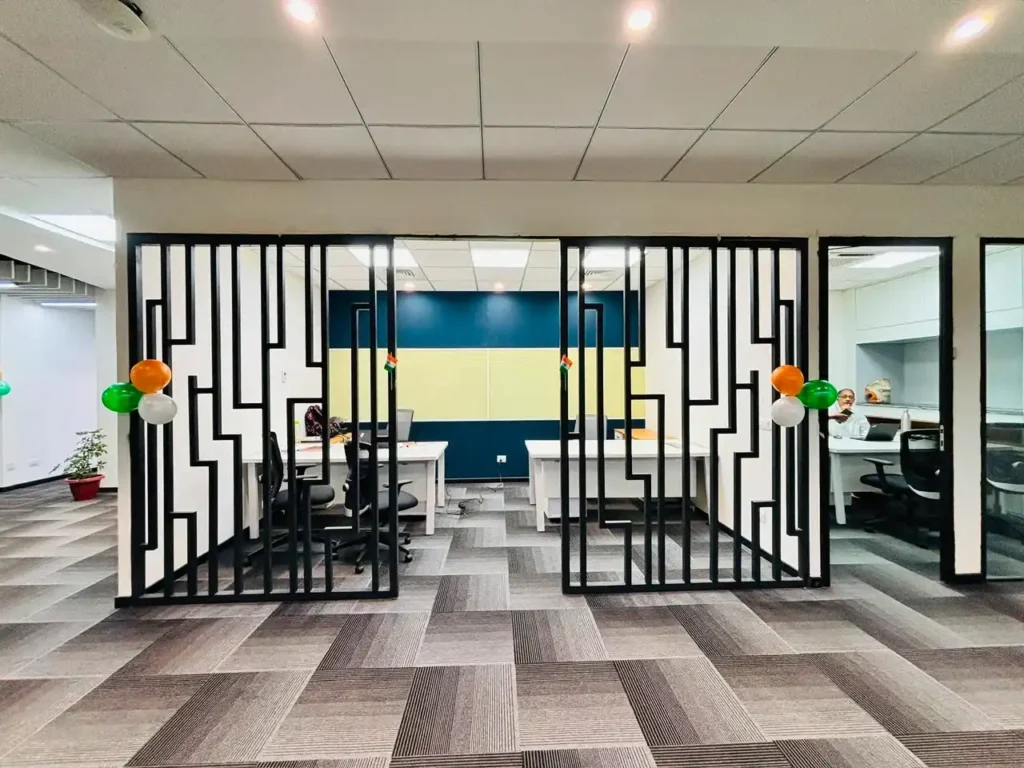 Elegant office reception and waiting area featuring premium false ceiling, lighting and designer partitions in Gurgaon.