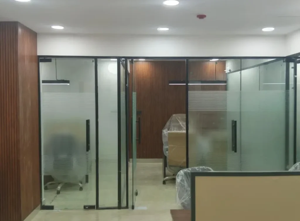 Modern office with glass partitions, executive cabins and premium workspace designed by Vision Infra & Interiors in Gurgaon.